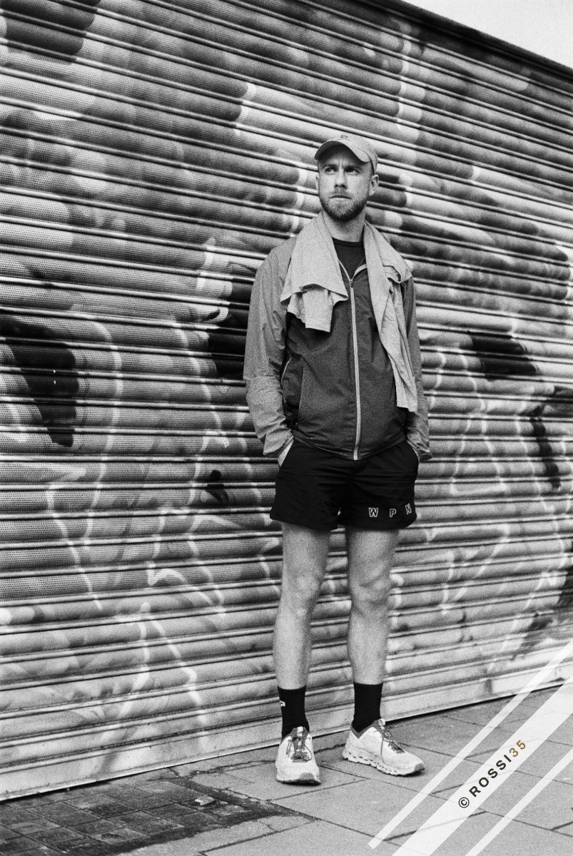 Runner against a shuttered wall